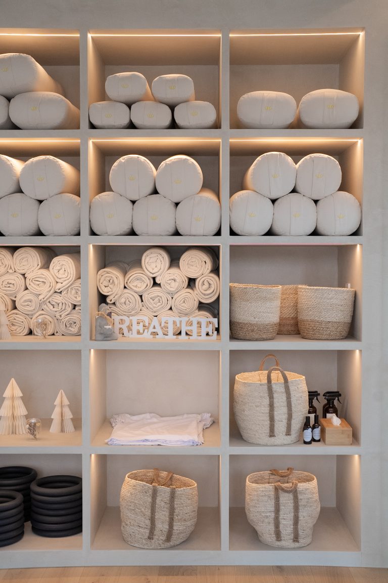 shelves filled with material for yoga and pilates classes